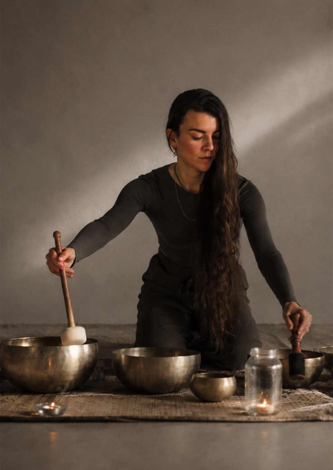 Stelina working with singing bowls in a sound session